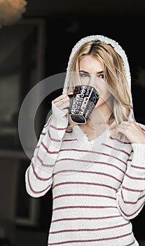 Soft portrait of teenage girl drinking hot coffee at home