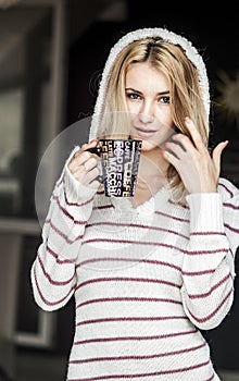 Soft portrait of teenage girl drinking hot coffee at home