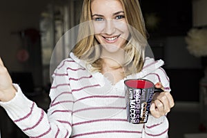 Soft portrait of teenage girl drinking hot coffee at home,