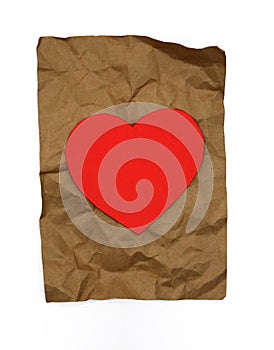 Soft red heart on brown wrinkled package paper.