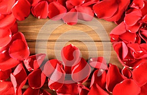 Soft Red rose petals on wooden background