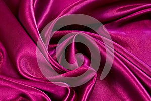 Soft red satin fabric swirled