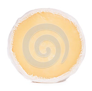 Soft round cheese wrapped in cheesecloth stand on its edge isolated photo