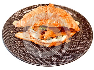 Soft shell crab croissant with brown plate