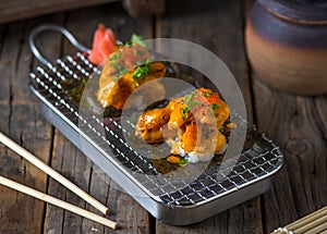 SOFT SHELL CRAB taco maki served in a dish isolated on wooden background side view of taco maki