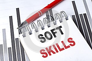 SOFT SKILLS text written on notebook with pen on chart