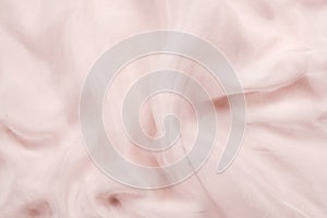 Soft smooth pink silk fabric background. Fabric texture