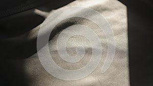 soft supple gray leather background with light streak from sun
