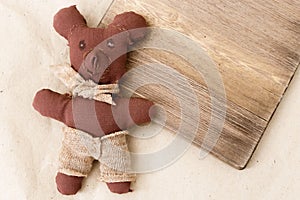 Soft toy of a bear is made by the child as a gift. Children`s creativity. Children`s hand-made sewn of fabric