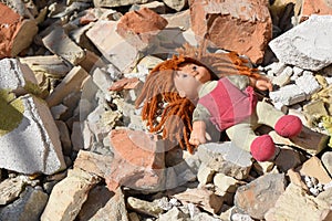 Soft toy doll amid the bricks and debris of destroyed house after the bombing.