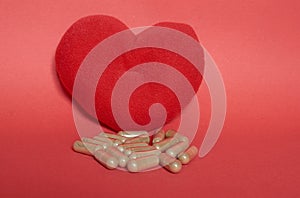 Soft toy heart and medicine in capsules