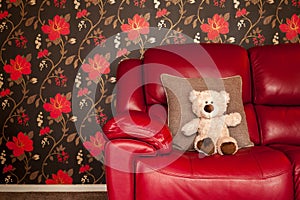 Soft toy on red sofa