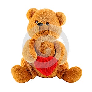 Soft toy teddy bear holding a heart-shaped pillow isolated