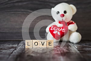 Soft toy white bear holding a heart and the word love, lined wit