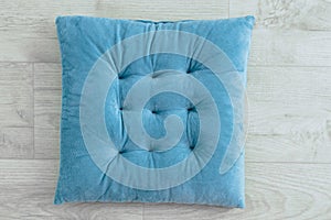 Soft turquoise chair seat cushion white wooden background
