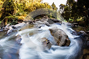 Soft water of the stream in the natural park, Beautiful waterfall in rain forest.