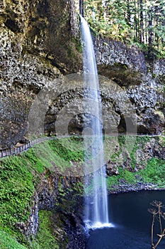 Soft Waterfall cascading onto blue azure water