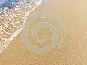 Soft wave of blue ocean on sandy beach. Background