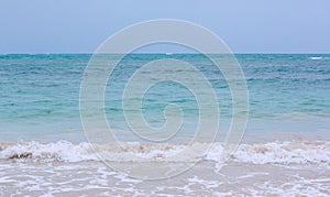 Soft wave of blue ocean on sandy beach. background. selective focus. beach and tropical sea white foam on beach.