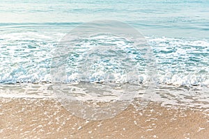 Soft wave of blue ocean on sandy beach. background. selective focus. beach and tropical sea white foam on beach. soft focus on bo