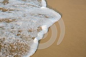 Soft wave of blue ocean on sandy beach. background. selective focus. beach and tropical sea white foam on beach. soft focus on bo