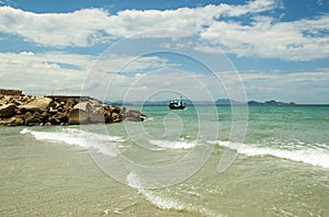 Soft wave of blue ocean on a sandy beach. With the blur. Toning