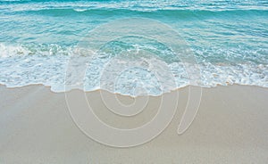 Soft wave of blue ocean on sandy beach. Summer vacation in island. clear azure water Background