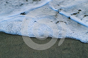 Soft Wave Of Blue Ocean On Sandy Beach. For using background. Selective focus. Sea Beach and Soft wave of blue ocean.