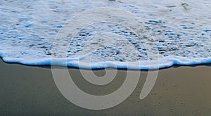 Soft Wave Of Blue Ocean On Sandy Beach. For using background. Selective focus. Sea Beach and Soft wave of blue ocean.