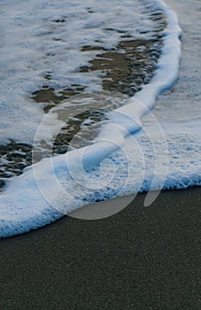 Soft Wave Of Blue Ocean On Sandy Beach. For using background. Selective focus. Sea Beach and Soft wave of blue ocean.