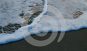 Soft Wave Of Blue Ocean On Sandy Beach. For using background. Selective focus. Sea Beach and Soft wave of blue ocean.