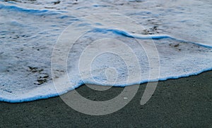 Soft Wave Of Blue Ocean On Sandy Beach. For using background. Selective focus. Sea Beach and Soft wave of blue ocean.