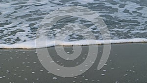 Soft Wave Of Blue Ocean On Sandy Beach. For using background. Selective focus. Sea Beach and Soft wave of blue ocean.