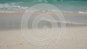 Soft wave of blue ocean on sandy white beach. summer background.