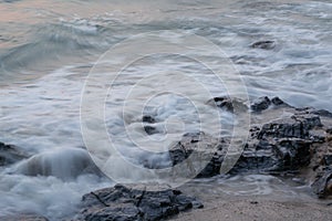 Soft wave is hitting the rocks.