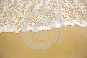 Soft Wave Ocean On Sandy Beach. Background. Selective focus.beach and tropical sea.white foam on beach.