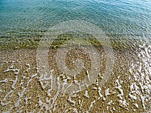 Soft wave of the sea on the sand beach for background