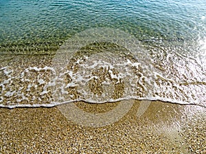 Soft wave of the sea on the sand beach for background