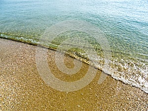 Soft wave of the sea on the sand beach for background