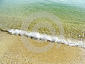 Soft wave of the sea on the sand beach for background