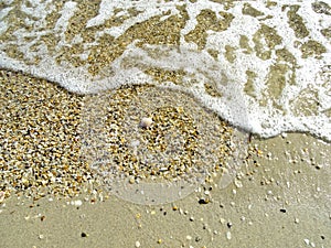 Soft wave of the sea on the sand beach for background