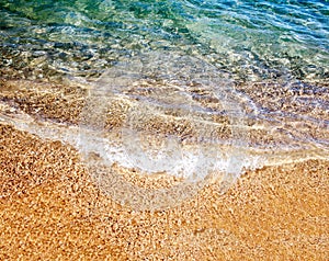 Soft wave of the sea on the sandy beach photo