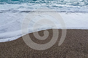 Soft waves foam in blue ocean italy coast, summer evening as background