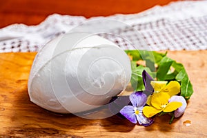 soft white italian mozzarella bufala campania cheese with green rocket salad leaves and viola