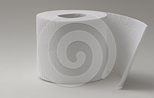 Soft white toilet paper roll with embossed pattern and partially unrolled sheet on a neutral background