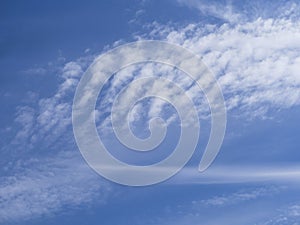 Soft white waves of clouds against the blue sky