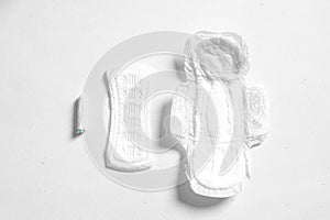 Soft white women`s pads and tampon  on white background. Close up photography for women`s or feminist blog