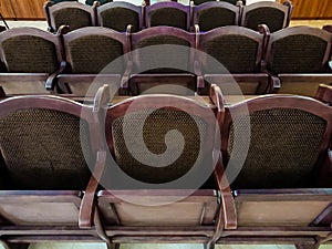 Soft wooden chairs in the auditorium. The interior in a public building