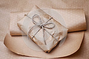 Soft wrapped postal packaging. Brown craft paper envelope. Hemp tie.