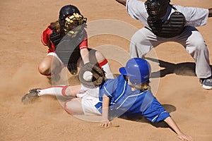 Softball Player Sliding Into Home Plate